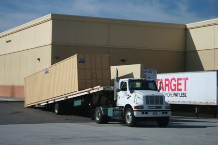 Portable storage container being delivered by truck to client in Riverside county provided by Sun Pac Storage Containers