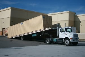 Portable storage container being delivered by truck to client in LA county provided by Sun Pac Storage Containers